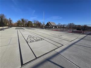 A photo of the Leisure Sports Area at Anzaldi Park (Shuffleboard Courts, Bocce Courts, Pickleball Courts and a Pavilion with Picnic and Game Tables).