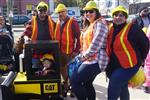 Photo of the Halloween Costume Contest - The Construction Crew, 4 Adults with vests and hardhats and child in a "Cat" bulldozer.